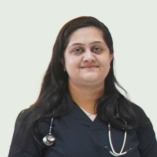 Portrait of Dr. Digita J. Bhati wearing dark scrubs and a stethoscope.